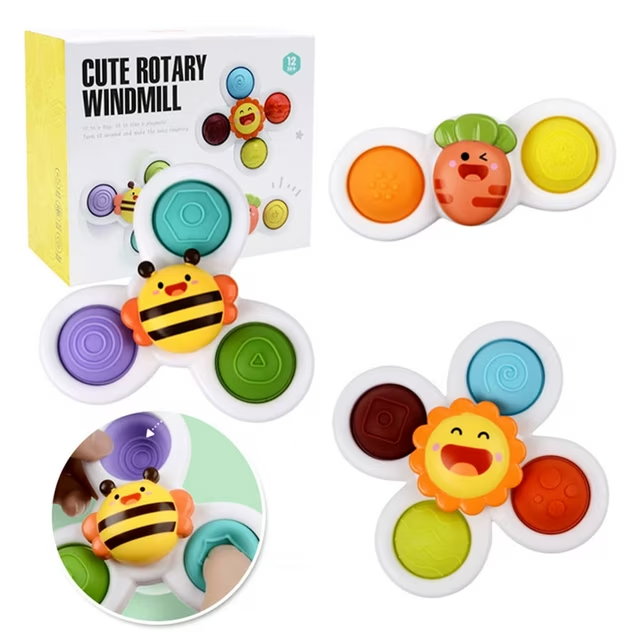 Three suction cup spinner toys — a bee, a carrot and a sunflower — with the box they come in